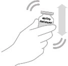 A hand holds a medication vial, shaking it vertically between two gray arrows and curved lines indicating motion