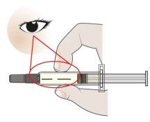 Medical illustration showing a hand holding a syringe with a red circle highlighting the device body connected to an eye