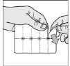 Two hands lifting and bending a transparent plastic sheet with a grid of vertical and horizontal lines and small black dots