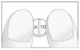Two fingers hold a small white capsule with black text A 10 on a light, neutral background