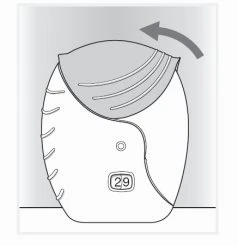 Disegno tecnico di un dispositivo medico con un coperchio superiore che viene sollevato verso sinistra tramite una freccia curva