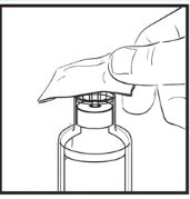 One hand lifts the protective cap of a glass vial to prepare the
