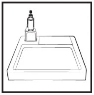 Black and white drawing of a vial with a black cap placed on a rectangular tray with a lateral recess designed to hold the vial