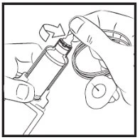 Two hands handling a glass vial and a syringe with needle to prepare the drug dose by aspirating the liquid