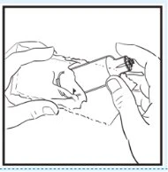 Two hands hold a medicine vial and a syringe to prepare the