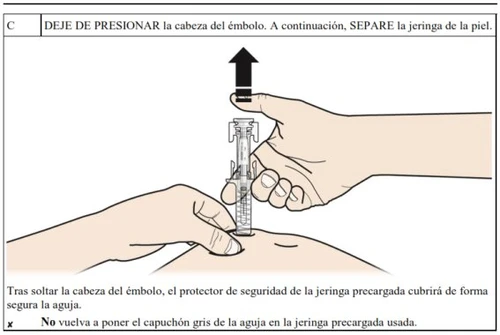 A hand pulls the plunger of the syringe upward toward the
