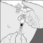 Two hands hold a medical device for administration