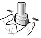 A hand holding a white and gray medical device with black arrows indicating lateral rotational movement