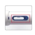 Close-up of a white medical device with a central rectangular window highlighted by a red border, showing an internal blue element