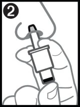 A hand inserting a nasal spray device into a nostril