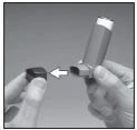 Two hands separate the cap from the body of an inhaler, with a white arrow indicating the motion of removing the top piece