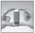 Two hands hold vertically a dark cylindrical vial with white cap for medication administration