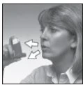 A woman holds a medical device near her mouth with two white arrows indicating the direction