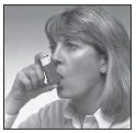 A woman with light hair holds a medicine box near her mouth as if to take a tablet or medication