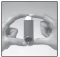 Two hands hold a dark cylindrical vial with a white cap vertically to show its shape and size