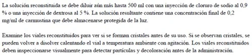 Text in Spanish on white background explaining how to dilute the carmustine solution and how to inspect reconstituted vials before use