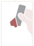 Una mano tiene un dispositivo medico composto da una parte allungata grigia e una sezione inferiore di colore rosso scuro