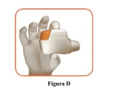 A hand holding a white medical device with an orange part for the