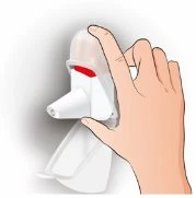A hand holding a white medical device with a transparent cap and a red part visible at the