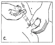 Two hands holding a syringe to inject liquid into a person's buttock