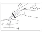 A hand pouring the contents of a liquid medication vial into