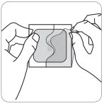 Two hands lifting the corners of a square patch with a dark, wavy central surface against a white background