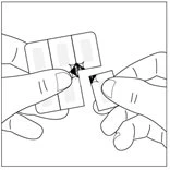 Two hands separate a rectangular medical adhesive patch into two parts along a central dotted cut line
