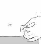 A hand holding a small rectangular object and bringing it close to the