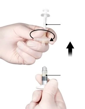 A hand rotating the upper part of a medical device while a