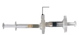 Transparent syringe with plunger and needle attached to a central connector with lateral wings for handling, on white background
