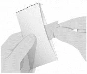 Two hands opening a white paper sachet folded along a dotted line at the top to remove its contents