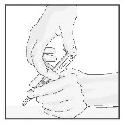 Two hands holding a syringe with the needle pointing downward to prepare the