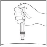 A hand vertically gripping a medical injection pen with the thumb on the top and the tip pointing downward