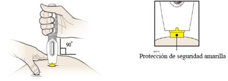 A hand holds a medical device vertically at a 90-degree angle against the skin with a magnified detail of the yellow protective cap