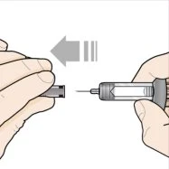 Two hands bringing together and attaching a needle to a syringe barrel, with a gray arrow indicating the leftward insertion movement