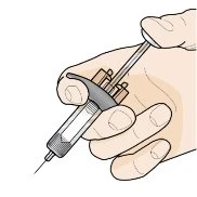 A gloved hand holding a syringe with needle pointing downward for medical administration