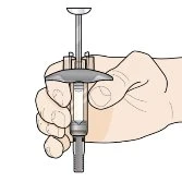 A hand firmly holding a transparent syringe with plunger and cylindrical body for drug administration