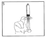 A hand holds a syringe vertically with the