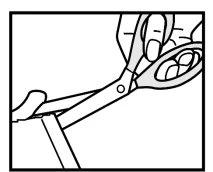 A hand holds a pair of scissors cutting the top of a medical container or blister pack