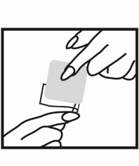 Two hands holding and opening a small gray rectangular wrapper or pouch to remove its contents