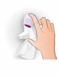 A hand holding a white medical device with a transparent cap and a purple section for the