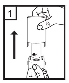 A hand holds the top part of a medical device while the