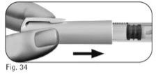 One hand holds a cylindrical medical device and moves it to the right as indicated by a black arrow on a white background