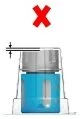 A large red cross positioned over a medicine vial with blue liquid and a level indicator with a horizontal black line