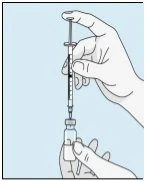 One hand holds a syringe vertically with the needle inserted into a small glass vial held by the second hand on a blue background
