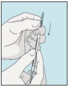 Two hands hold a syringe with needle and a glass vial to prepare the medication dose