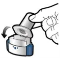 A hand lifting the cap from a cylindrical medical device, with a black arrow indicating the opening movement downward