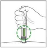 Una mano impugna un dispositivo medico cilindrico con un indicatore verde all'estremità