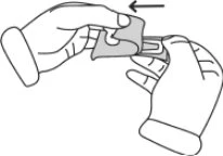Two hands holding and opening a drug container or packaging with a black arrow indicating movement to the left