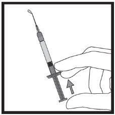 A hand holding a syringe with needle pointing towards the